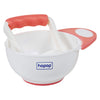 Parent mashing vegetables in baby feeding bowl